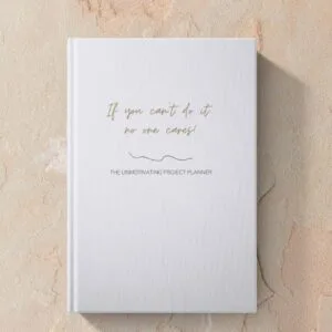Mock up image of hardcover funny unmotivating project planner sitting on a desk. Light blue matte cover "If you can't do it, no one cares."