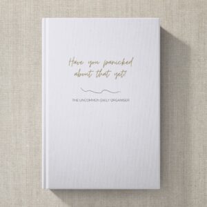 Mock up image of hardcover funny unmotivating project planner sitting on a desk. Light blue matte cover