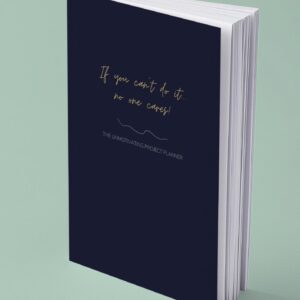 Mock up image of paperback funny unmotivating project planner. Dark blue matte cover "If you can't do it, no one cares."