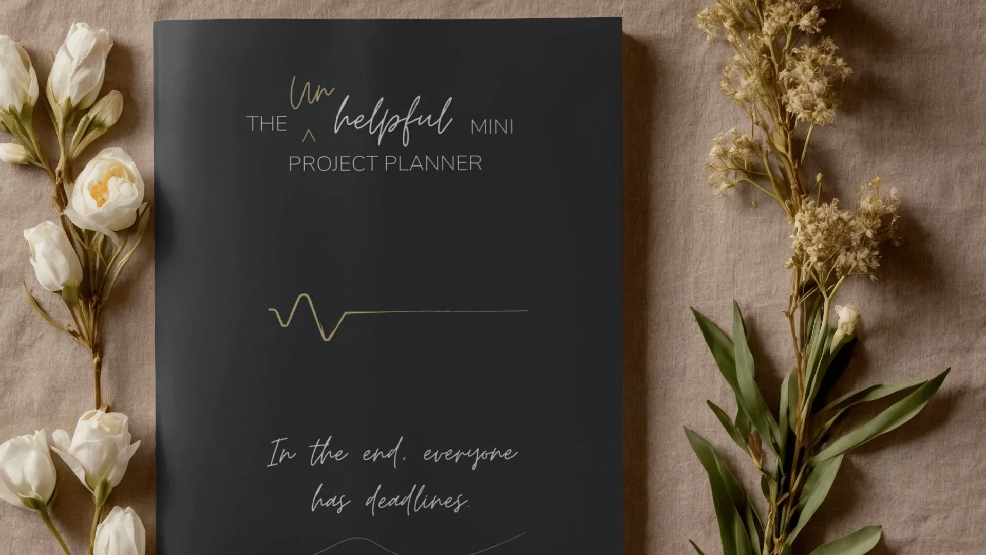 The unhelpful mini project planner. A5 mini project planner black cover mock up image.