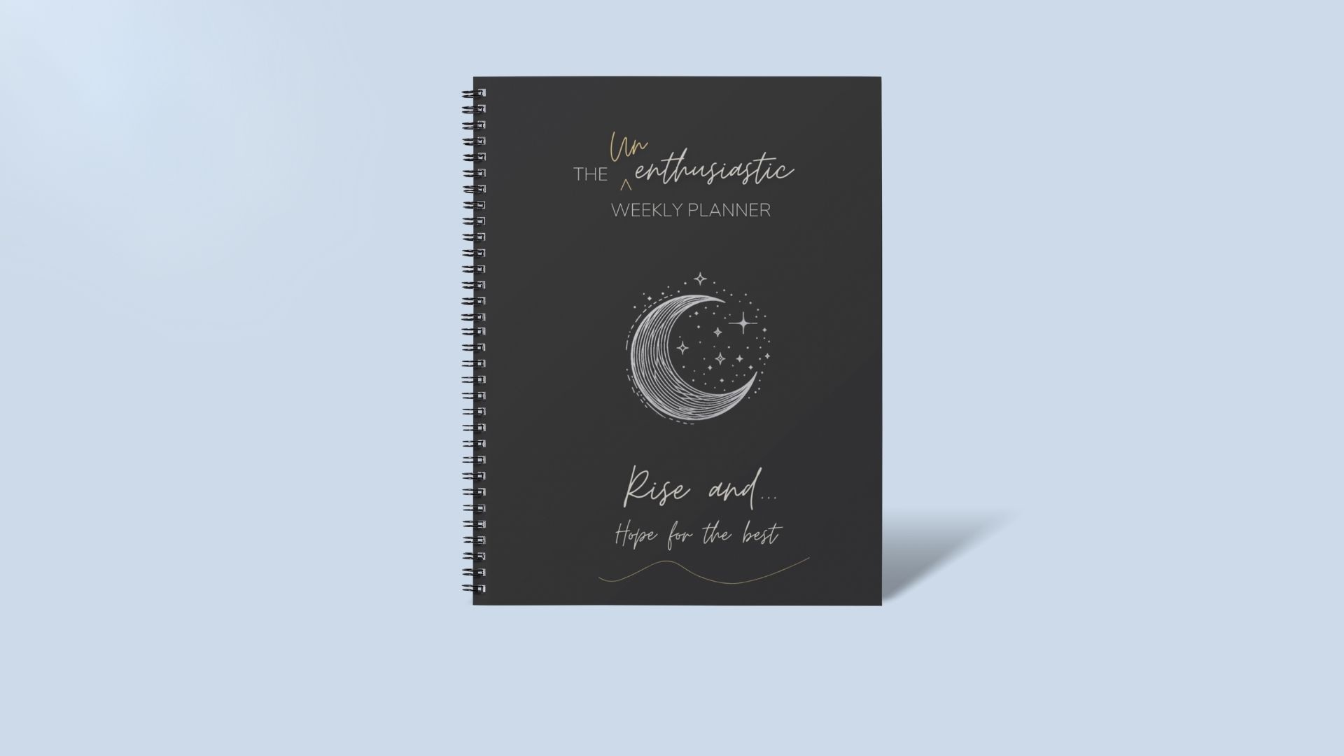 Unenthusiastic Weekly Planner mock up image of coil bound weekly planner on blue background.