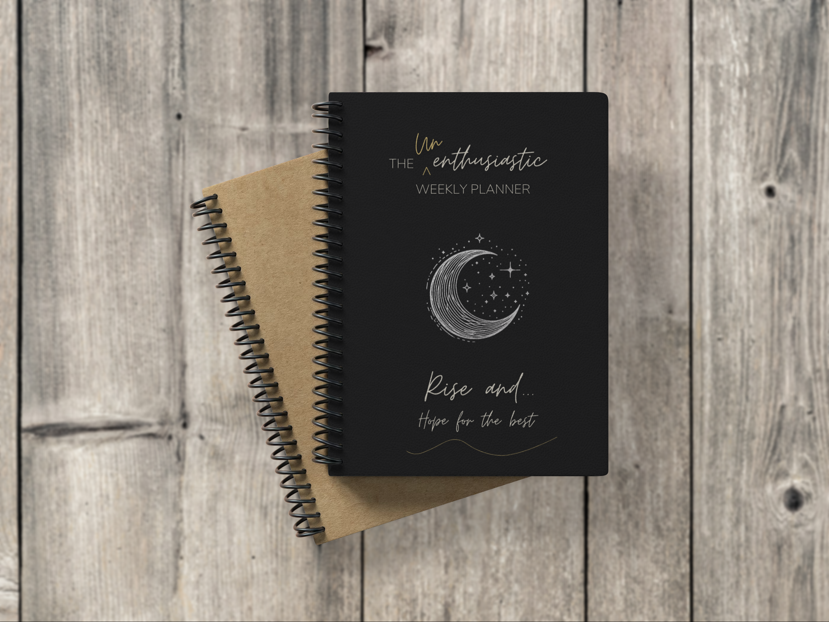 Unenthusiastic Weekly Planner mock up image of coil bound weekly planner on grey wood background.